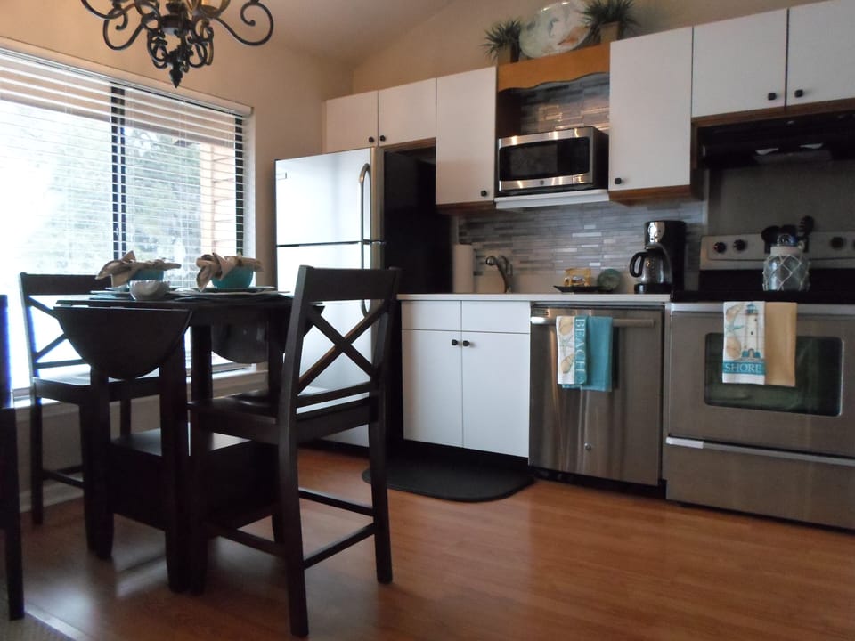 new stainless appliances,new café table set with dishes/cooking utensils