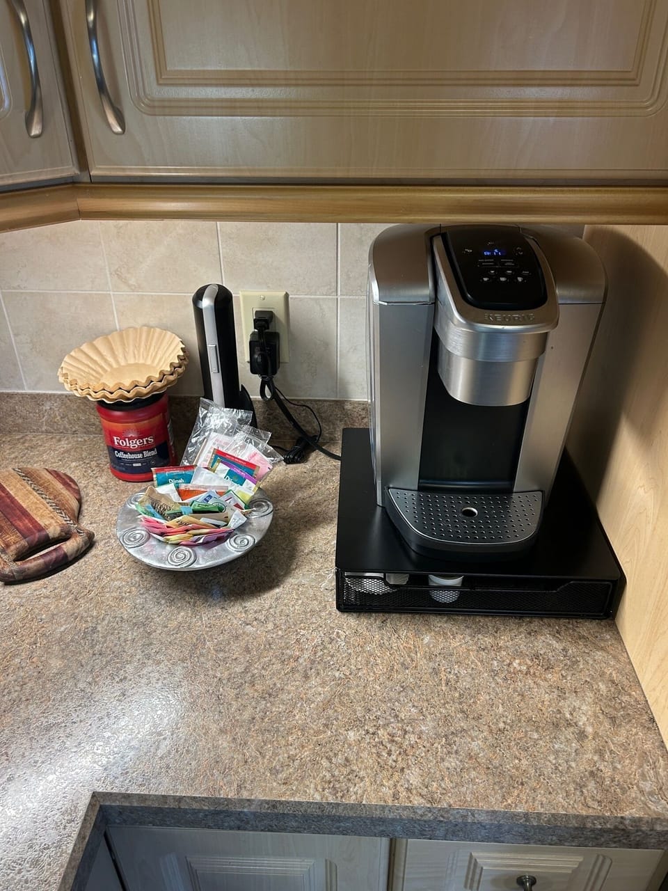 Keurig and full coffee pot in unit with electric wine opener