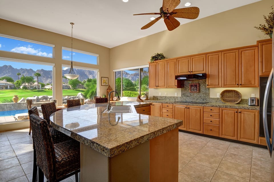 View from the kitchen with seating for 5 around the kitchen island.