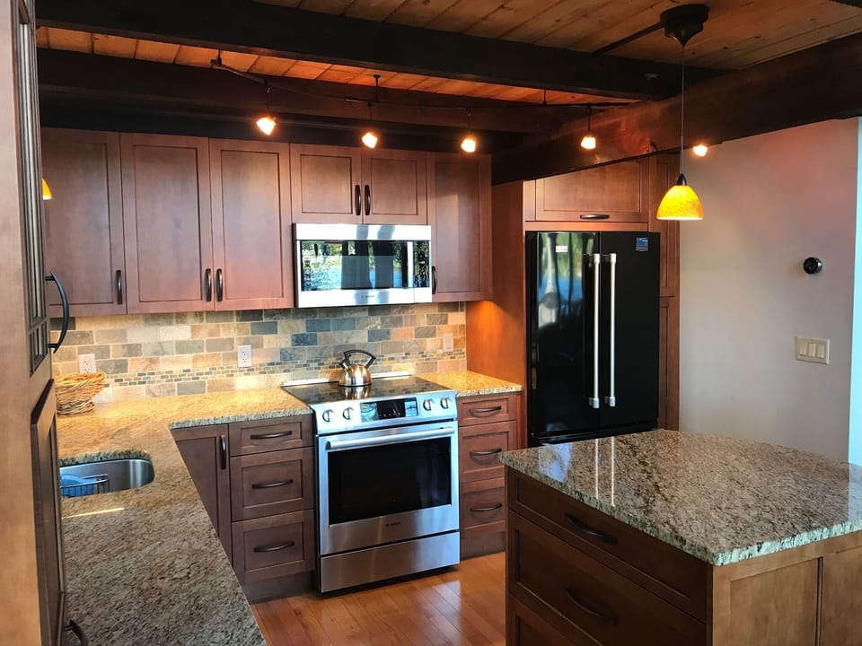 Custom stainless, maple, & granite kitchen - espresso beams - V-groove ceiling