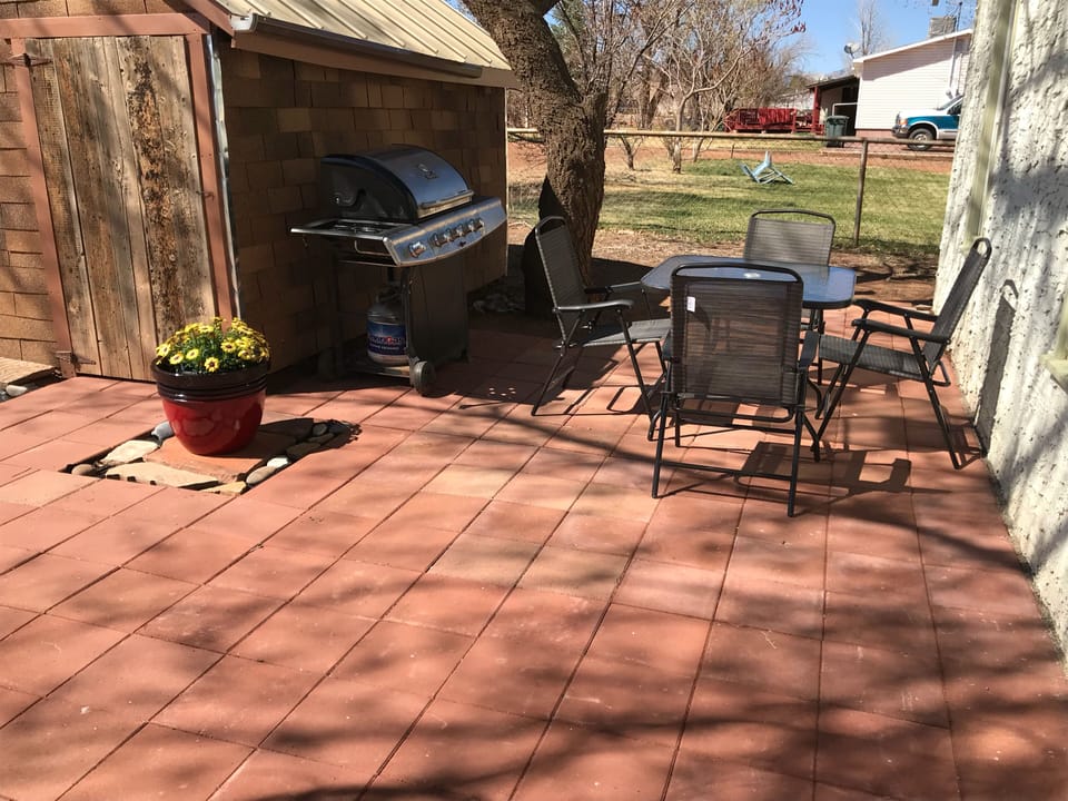 Backyard patio with barbecue grill and outdoor dining table