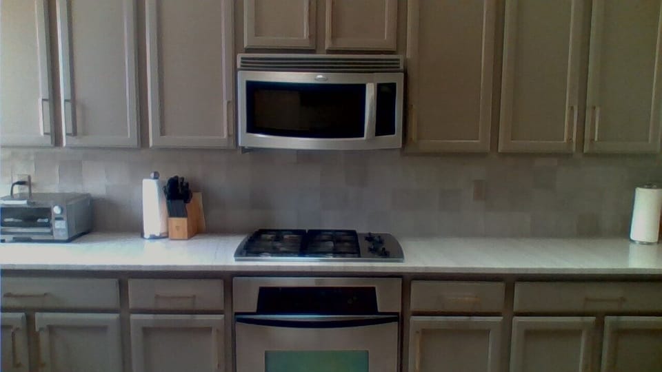 Quartzite counters, gas cooktop.