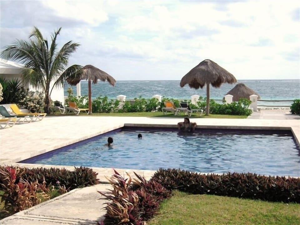 pool and ocean beyond your patio and living room