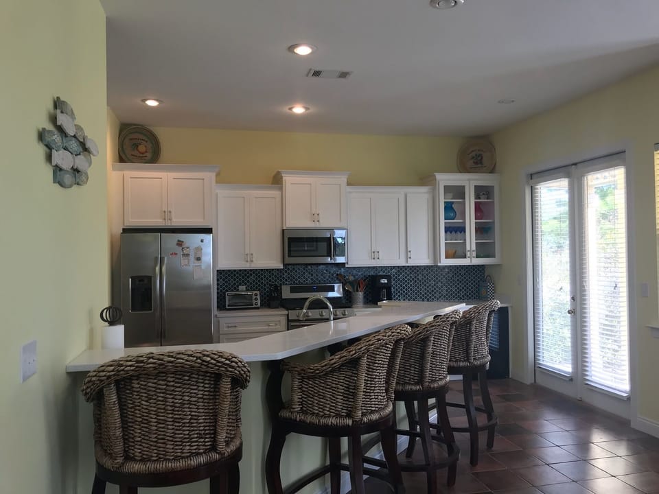 new kitchen with counter and 4 large barstools