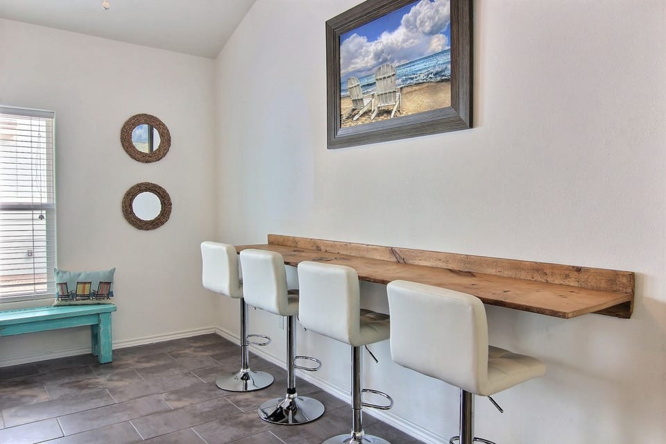 Wall bar in living room provides extra dining space. Also 4 wooden TV tables.