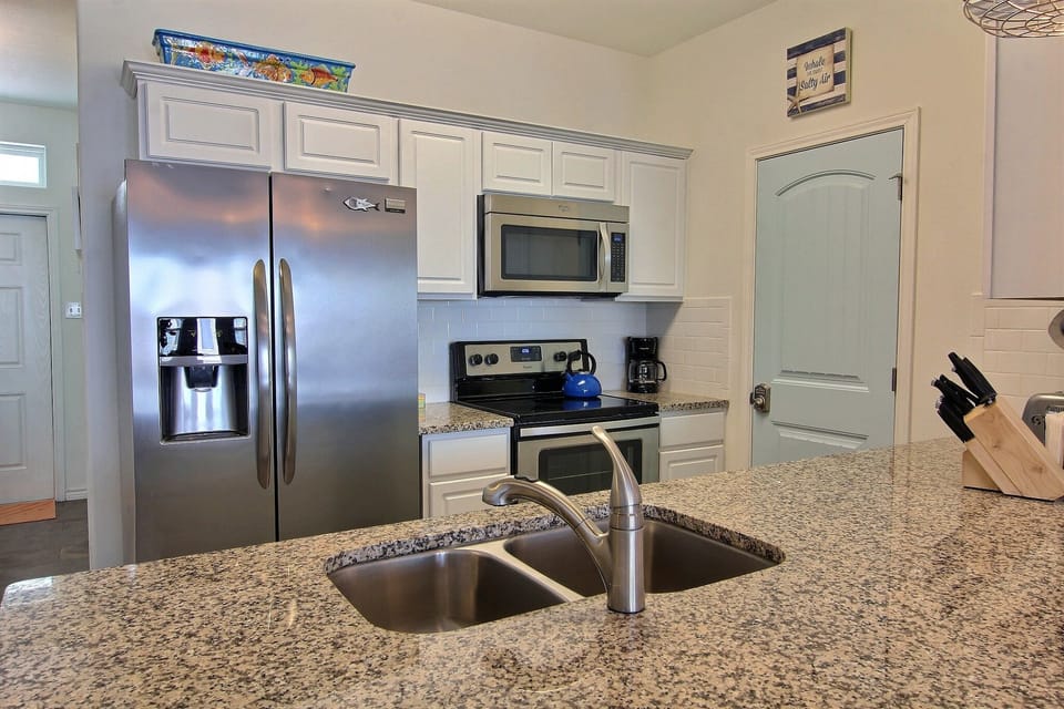 Fully equipped, brightly lit kitchen.