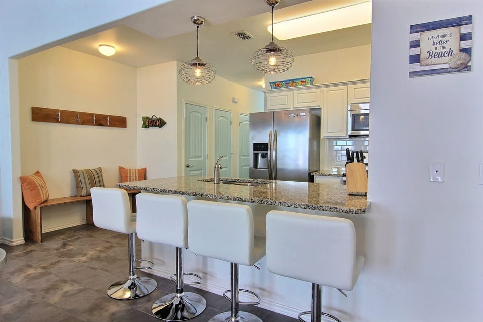 Breakfast bar, kitchen, pantry closet and washer/dryer closet.