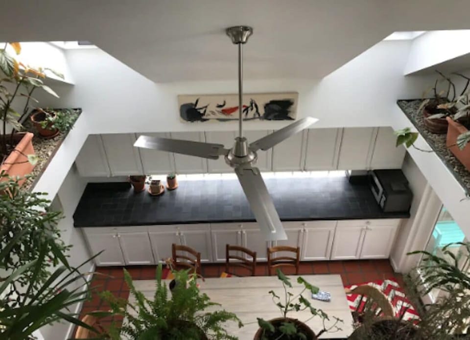 View from upstairs living room into garden dining room, seats 8
