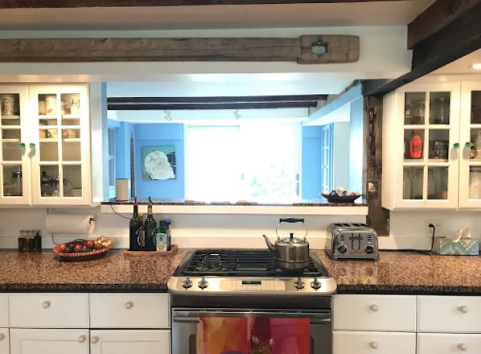 Kitchen, view into breakfast dining area and outside toward the water, gas stove