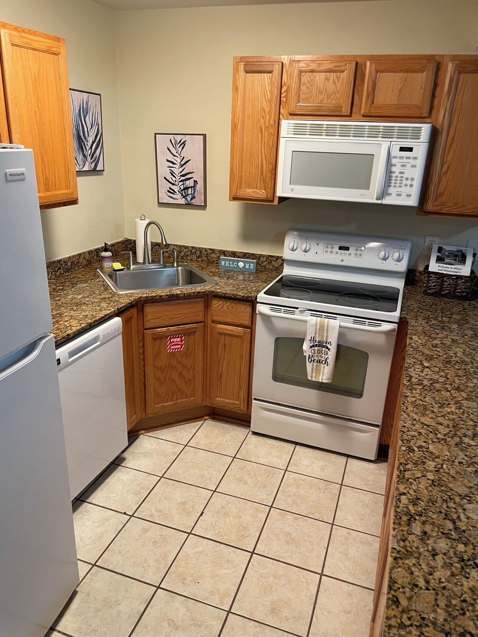 Kitchen includes appliances: refrigerator, stove/oven, microwave and dishwasher.