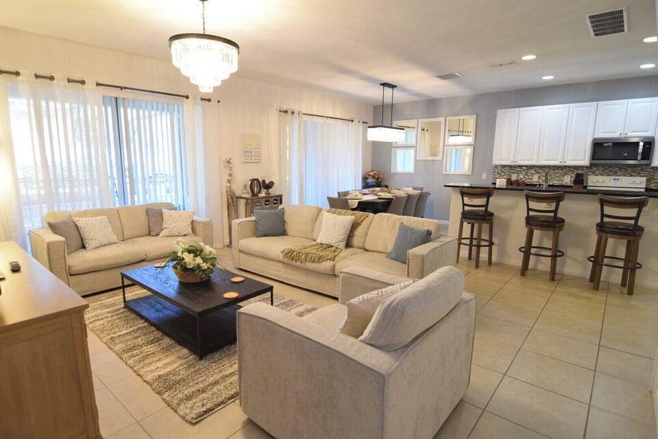 Lounge area with Smart TV, sofas, views to the pool deck