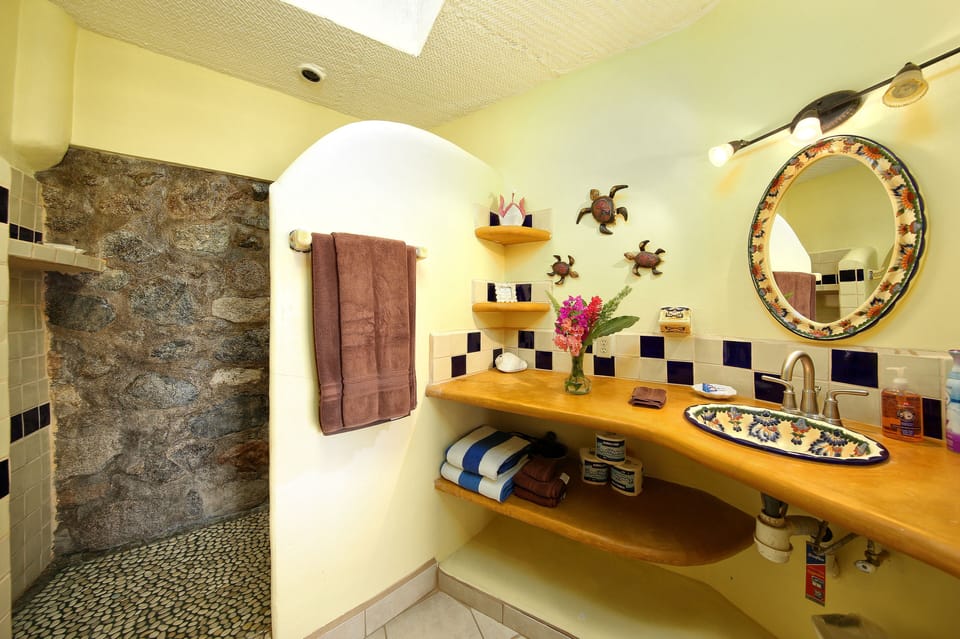 Full Bathroom with local stonework and skylight