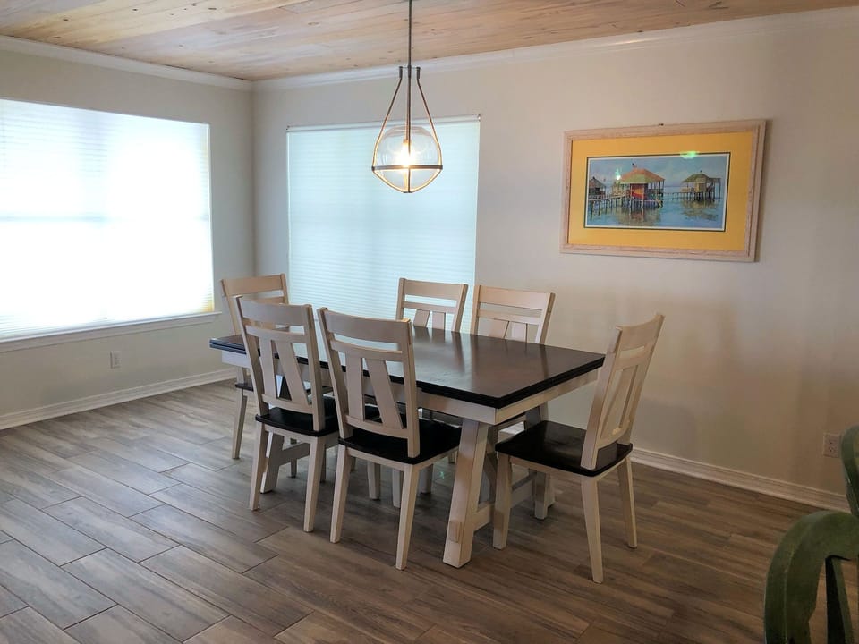 Gather around this spacious dining table where you'll create lasting memories over delicious meals with loved ones in this bright, welcoming space.