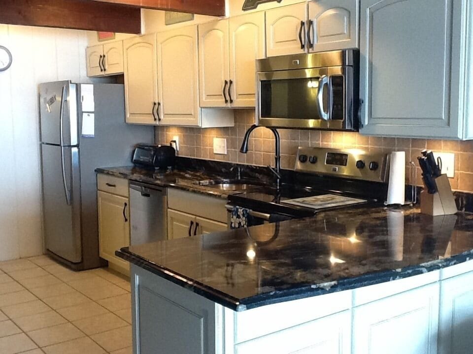 Kitchen w/stainless steel appliances, 2 refrigerators, & breakfast bar