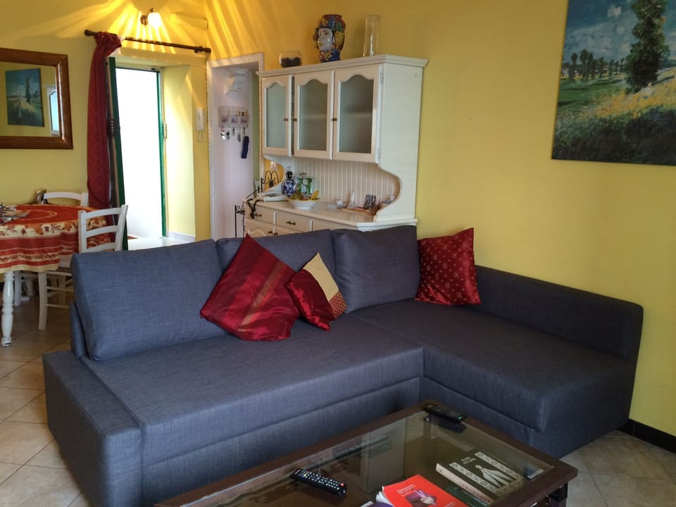 New double sofa bed in lounge area and front door leading to outside terrace. 