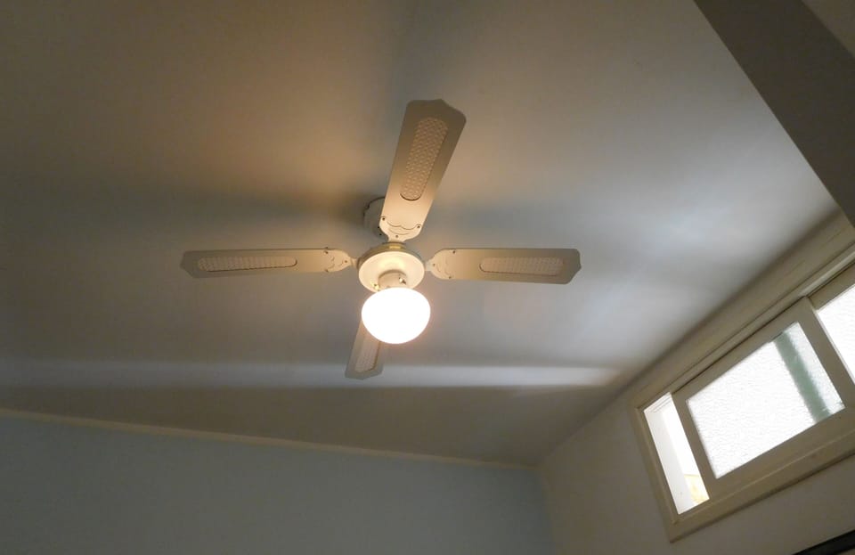 New ceiling fan operated by remote control in twin bedroom. No exterior window.