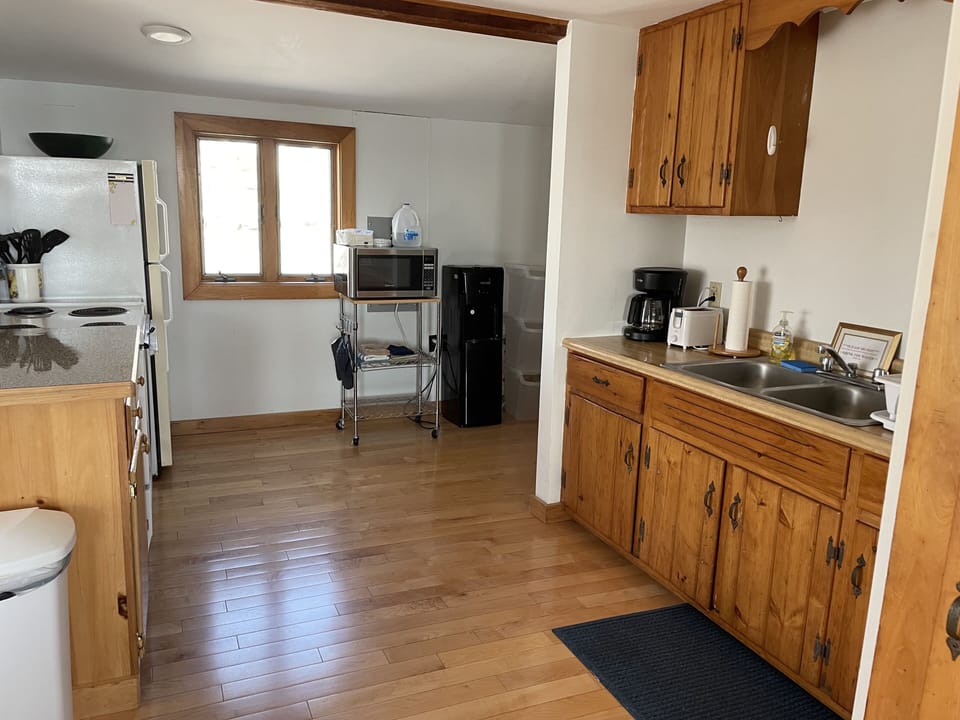 Functional kitchen with coffee maker, toaster and microwave.