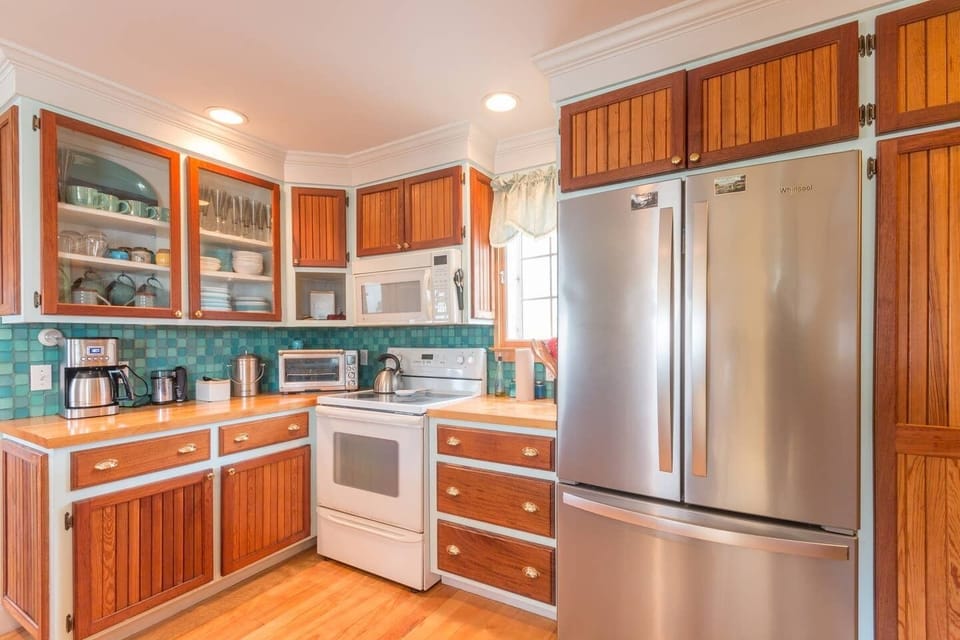 Bright, airy gourmet kitchen stocked with full cooking, baking, and serving gear