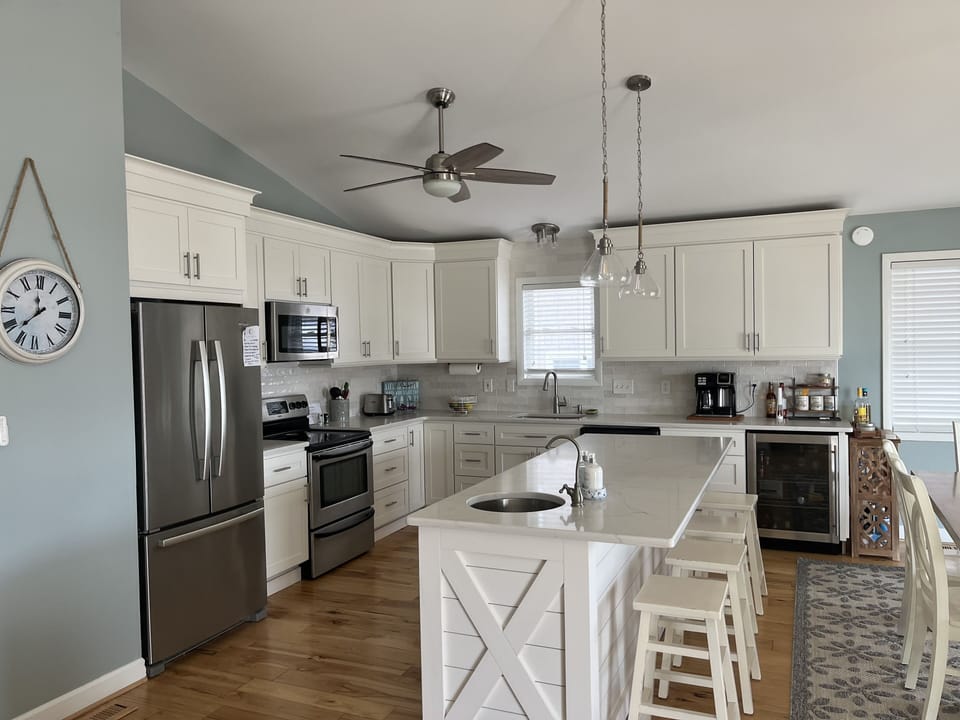 Recently updated kitchen with beverage center, prep sink and quartz countertops