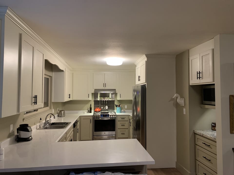 Newly renovated kitchen with gas stove and refrigerator with ice maker. 