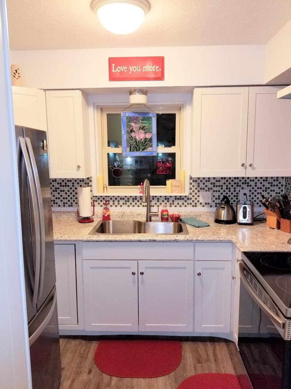 Large farm sink.  Drainboard and supplies under sink.