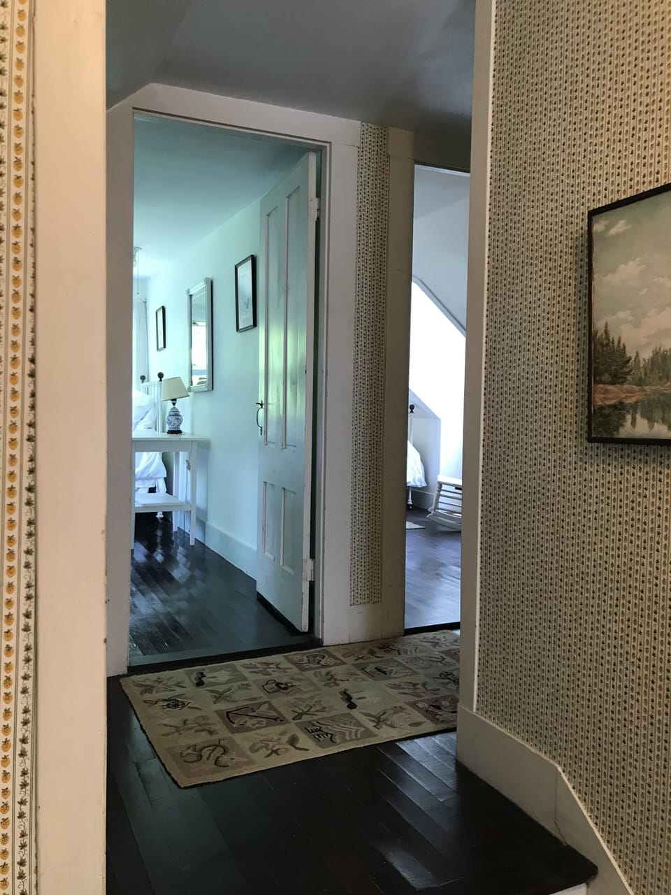 Hallway view looking into 2 different double bedrooms