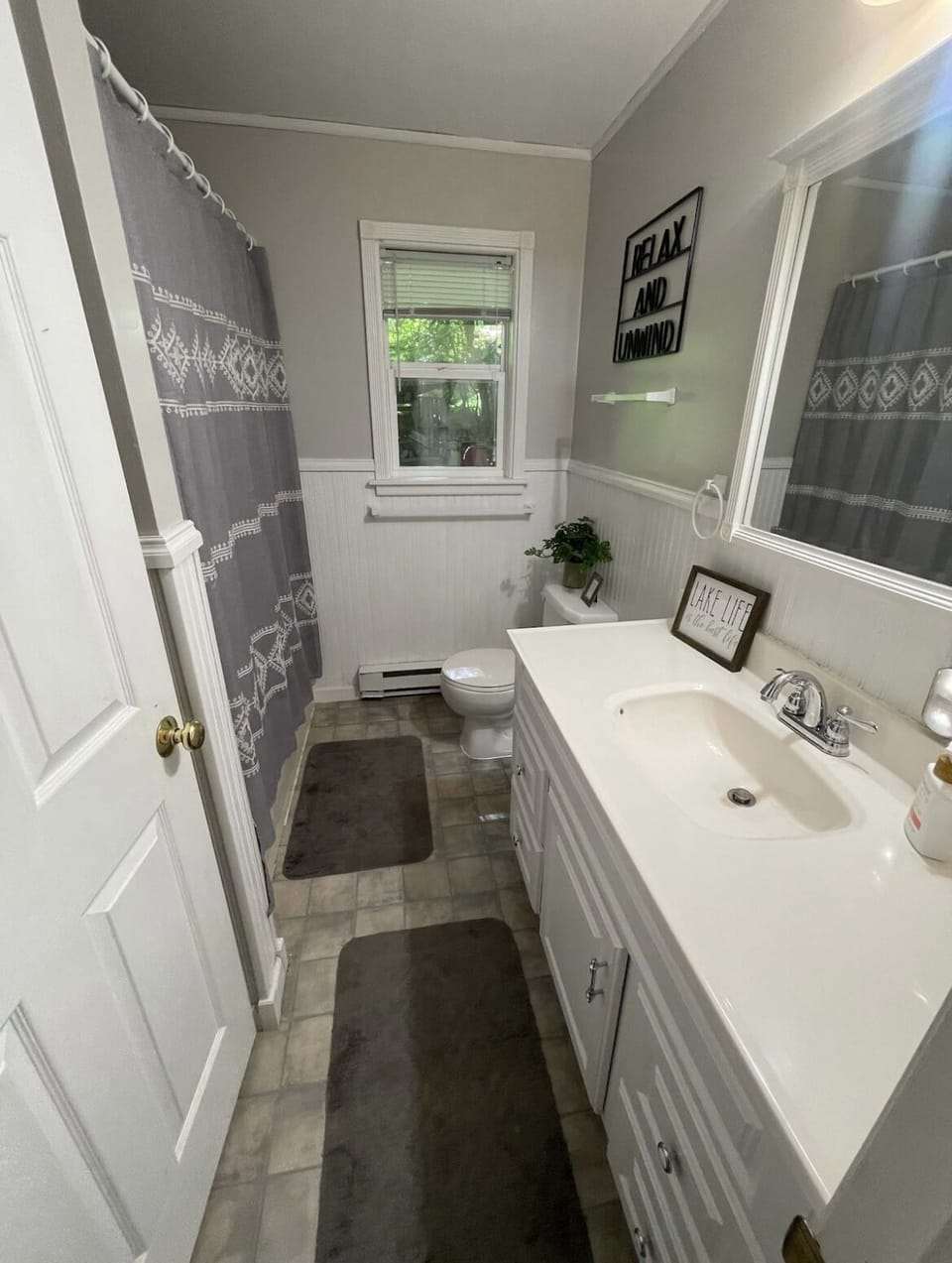 Fully stocked including hand soap, shampoo, body wash, and toilet paper.