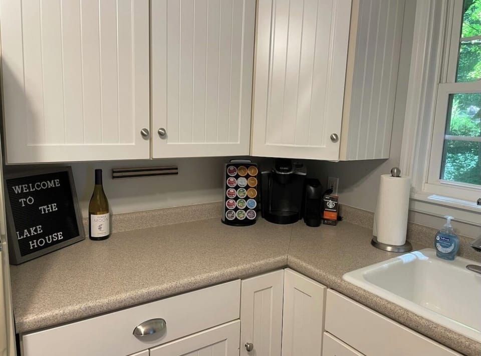 Both a Keurig and Nespresso machine, stocked with a selection of pods.