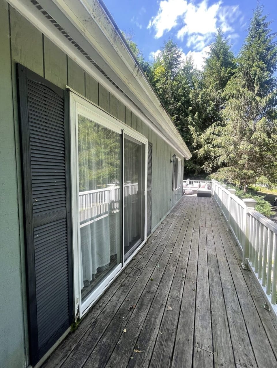 The master bedroom opens directly onto the expansive wraparound deck.