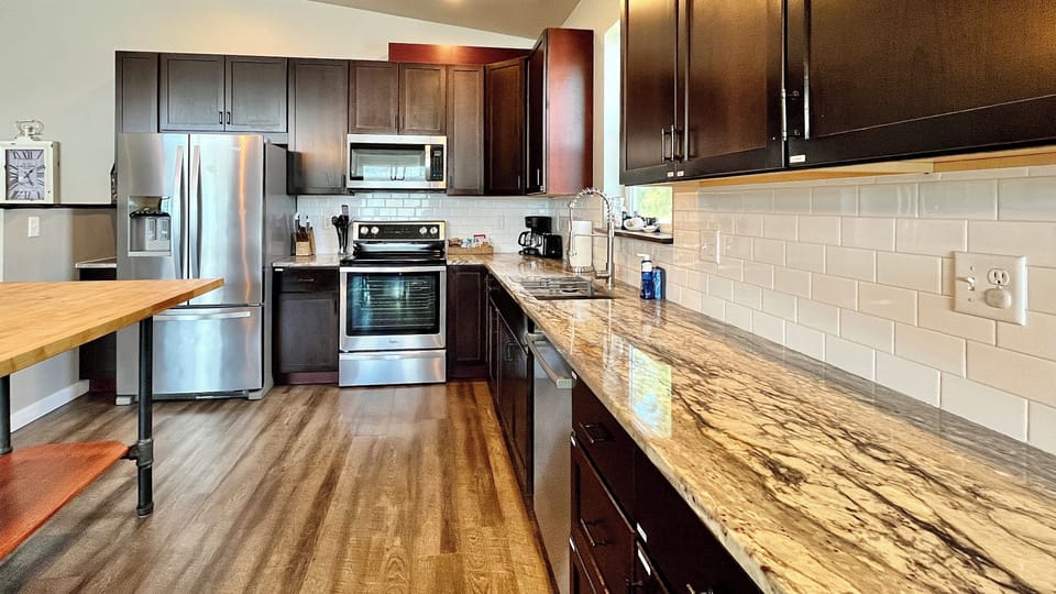 Kitchen with granite countertops and butcher-block island