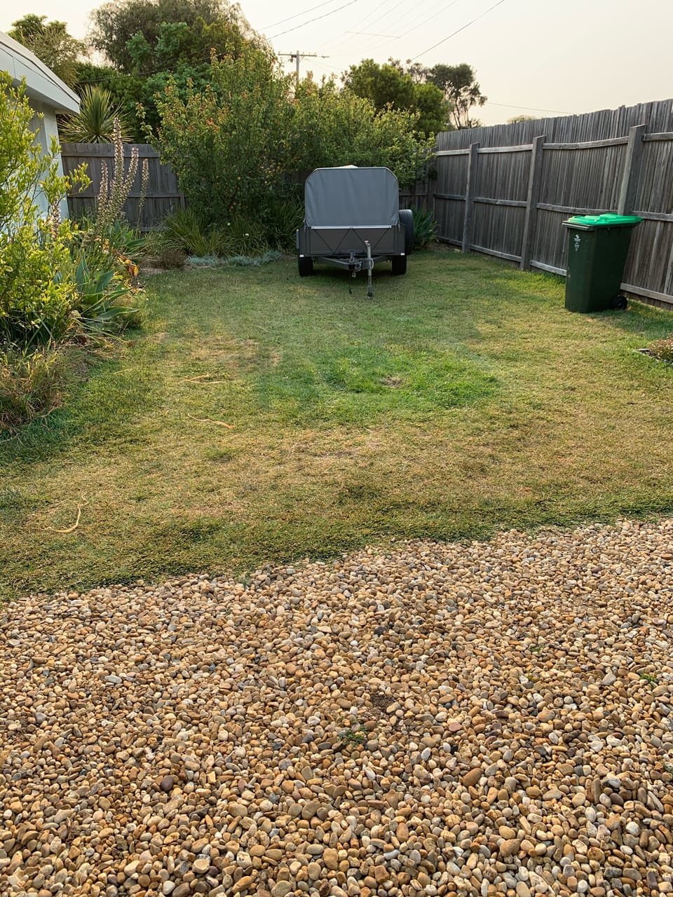 Fully fenced front yard perfect for storing a boat/trailer.