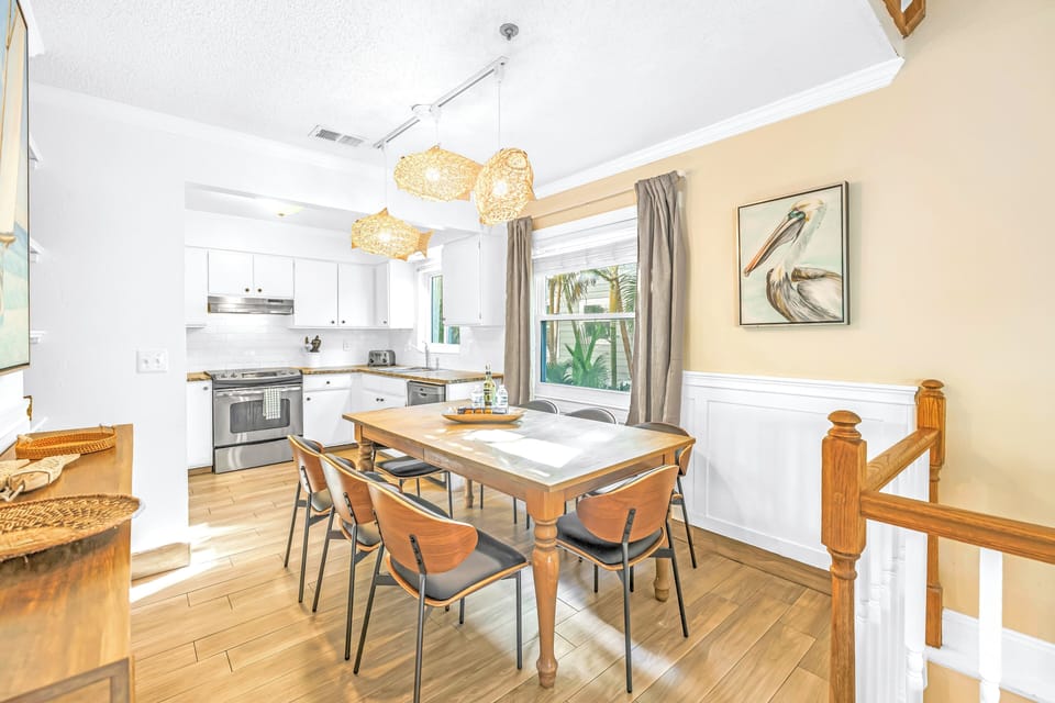 Dining area just outside kitchen with painting of a Florida brown pelican.