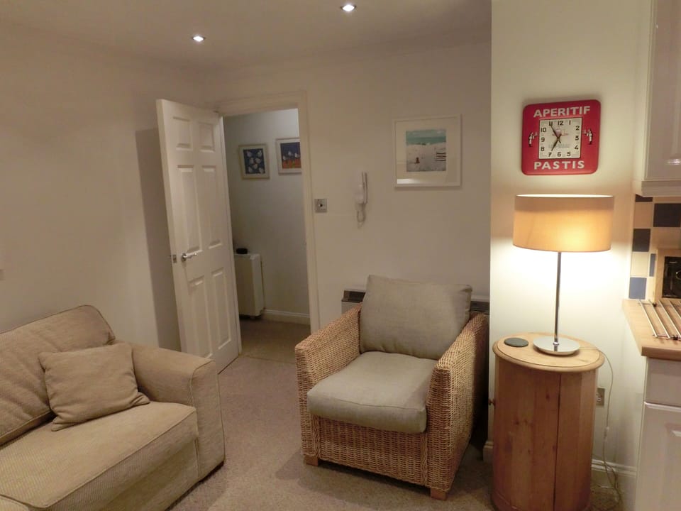 Sitting room through to hallway.  Leads left to bedroom and right to bathroom 