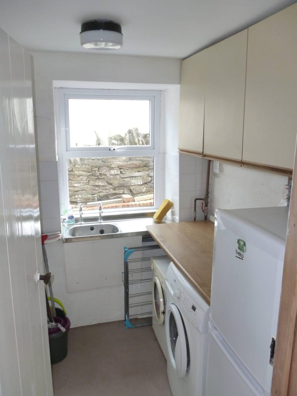 Utility room with washing machine/tumble dryer and fridge freezer