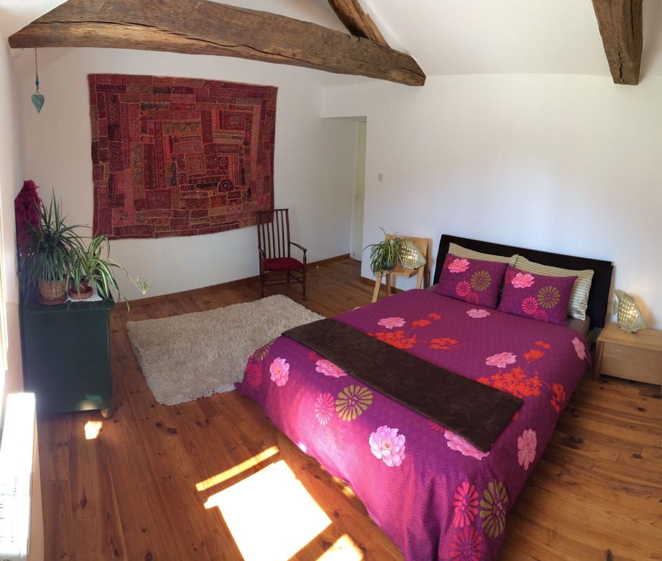 Light and spacious double bedroom with original oak beams.