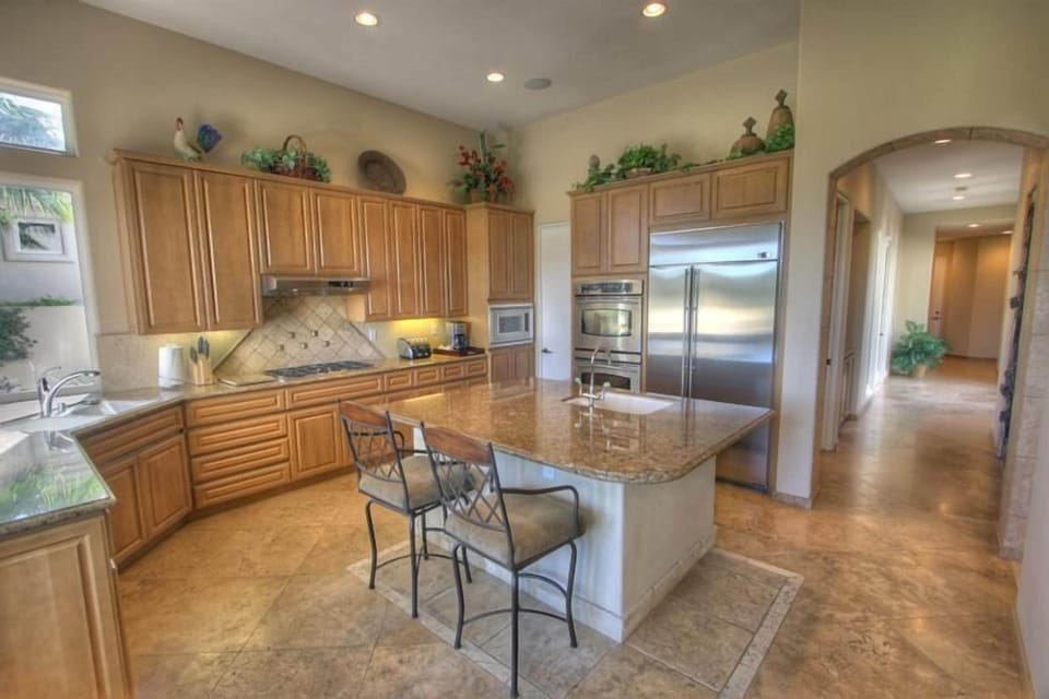 Kitchen features GE Profile ss appliances, center island & walk-in pantry.
