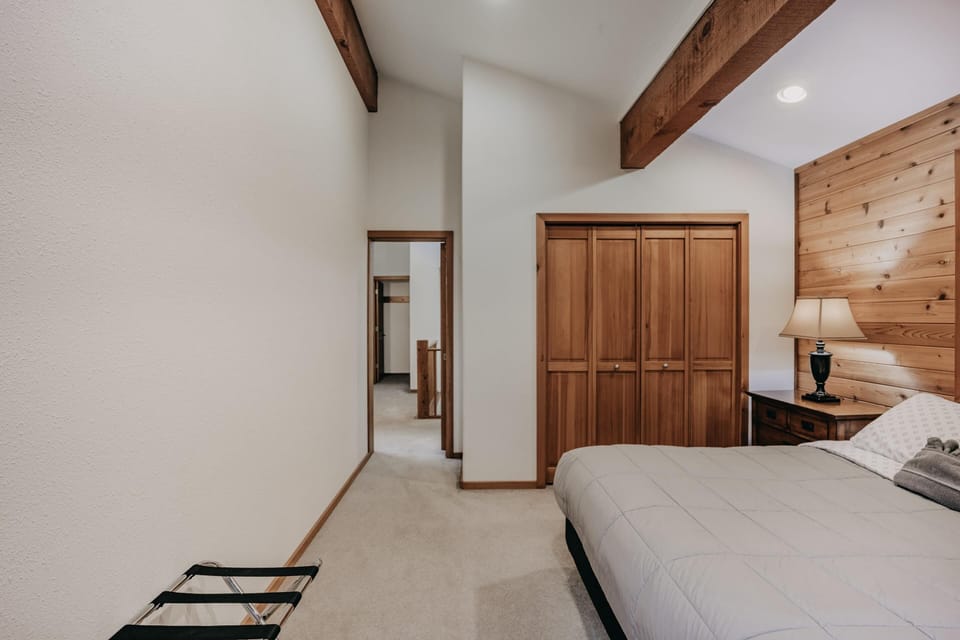 Cozy bedroom retreat with rustic wood accents and vaulted ceiling