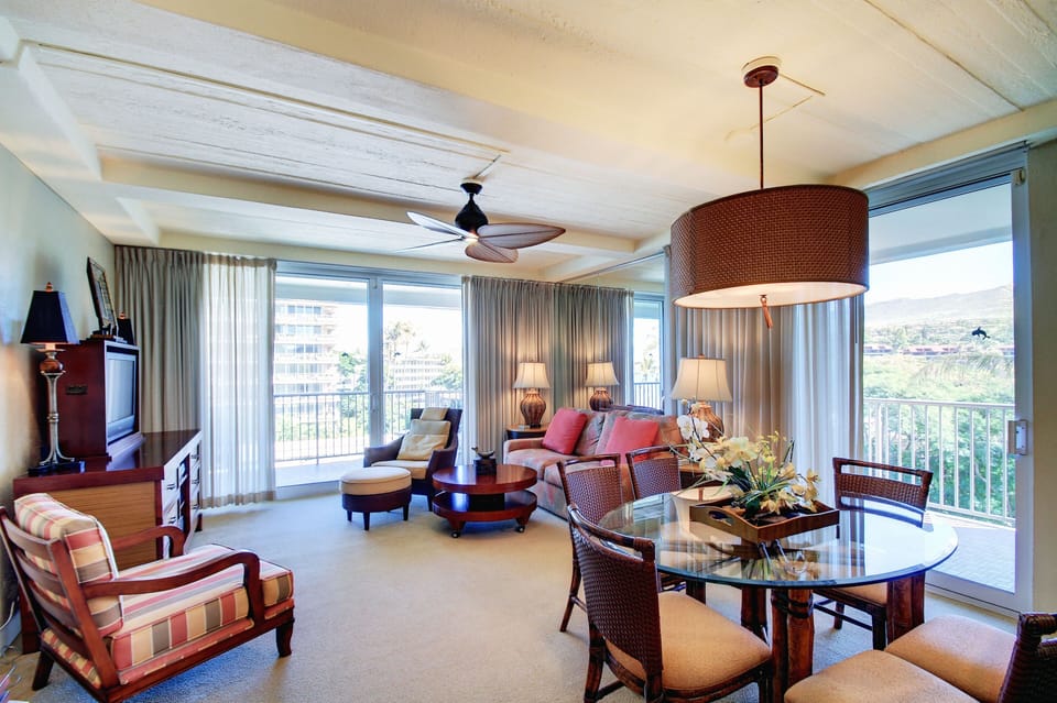 Living Room with sofa sleeper, two sliders and wrap around lanai