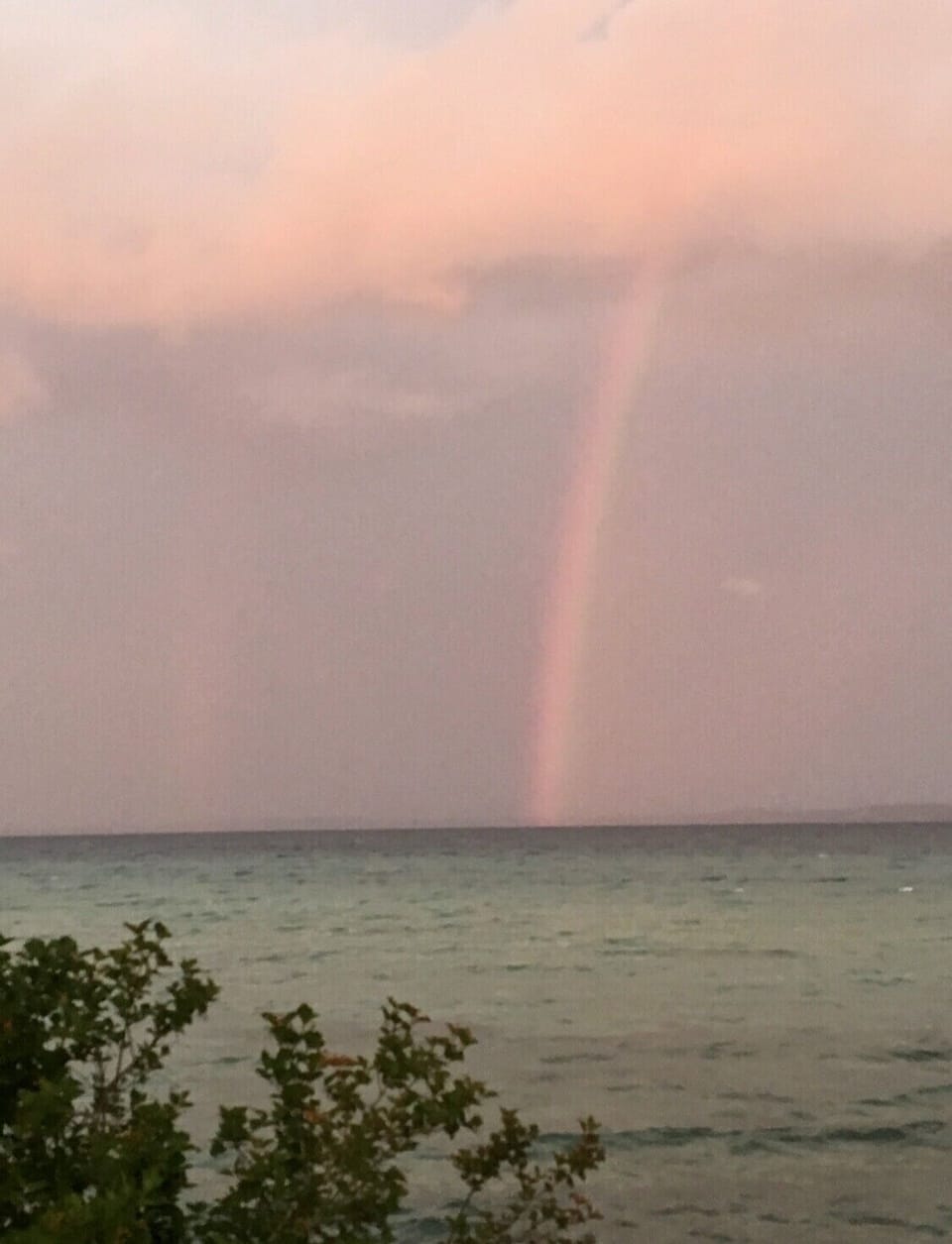 Rainbow shining on Old Mission Peninsula, view from beach.