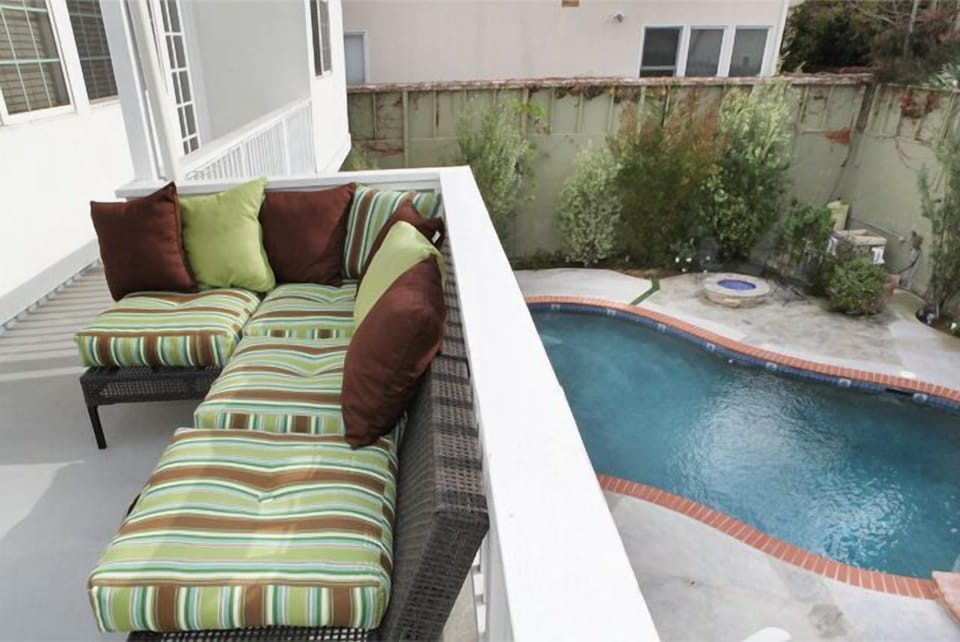 Upstairs deck off kitchen with barbeque overlooking pool