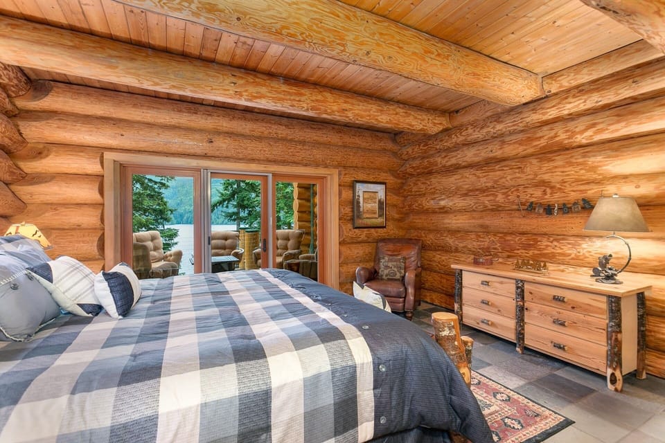 Downstairs master suite with double doors to lake-view deck and gas fire pit.