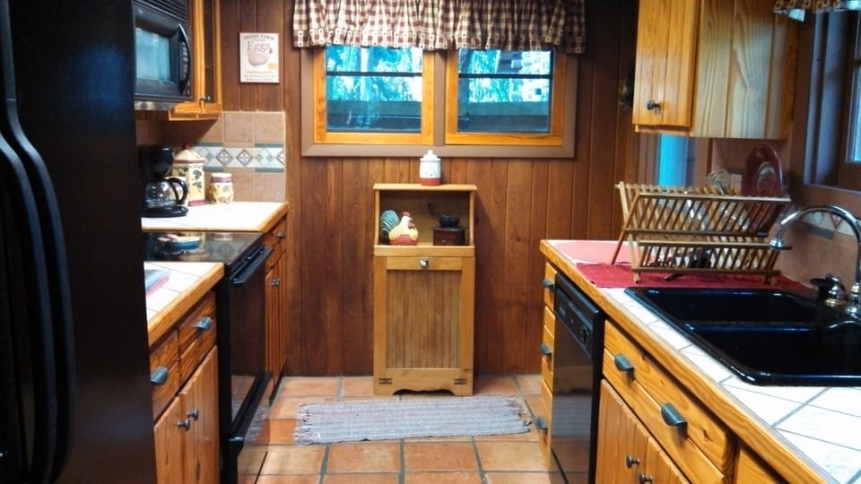  fully stocked kitchen and side door to the deck and washer-dryer room