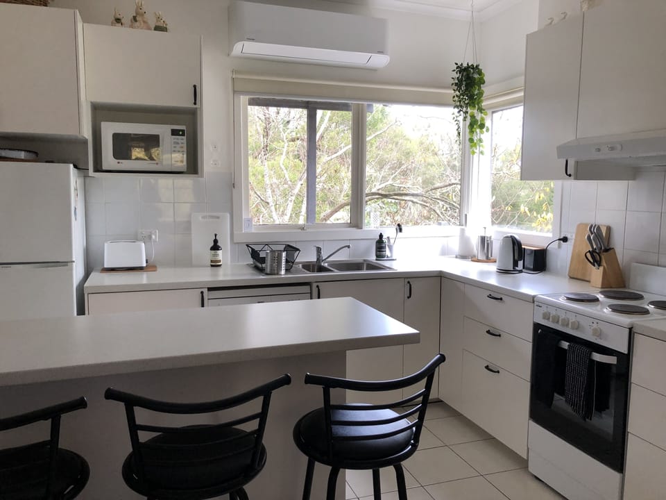 Sunlit, fully equipped kitchen with birdwatching views, overflowing with wares