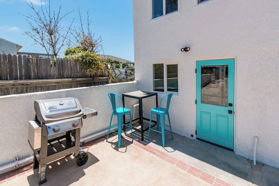 Common area space with grill (one of two located in complex) and laundry room