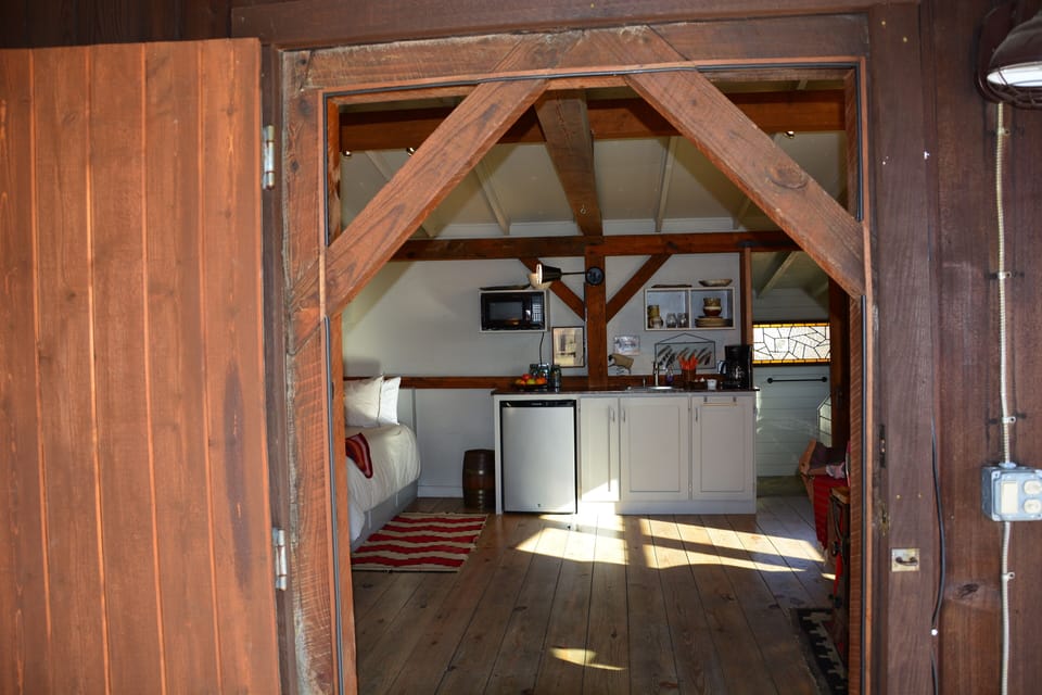 The rough-hewn beams and pine plank floors are  rustic and welcoming.
