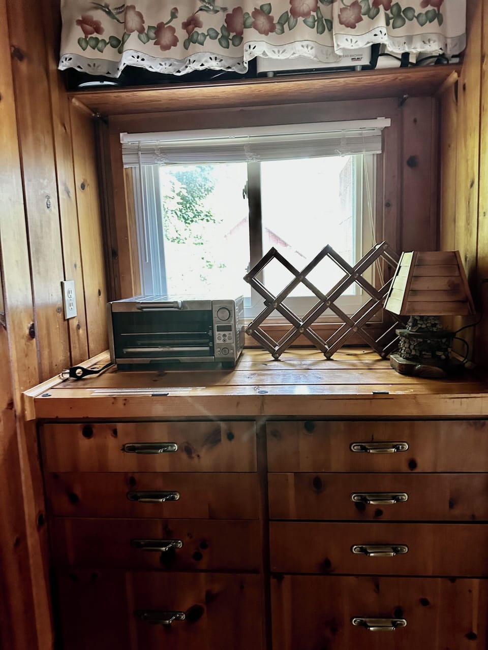 Charming knotty pine built-ins for tons of storage, bonus Breville Toaster oven 