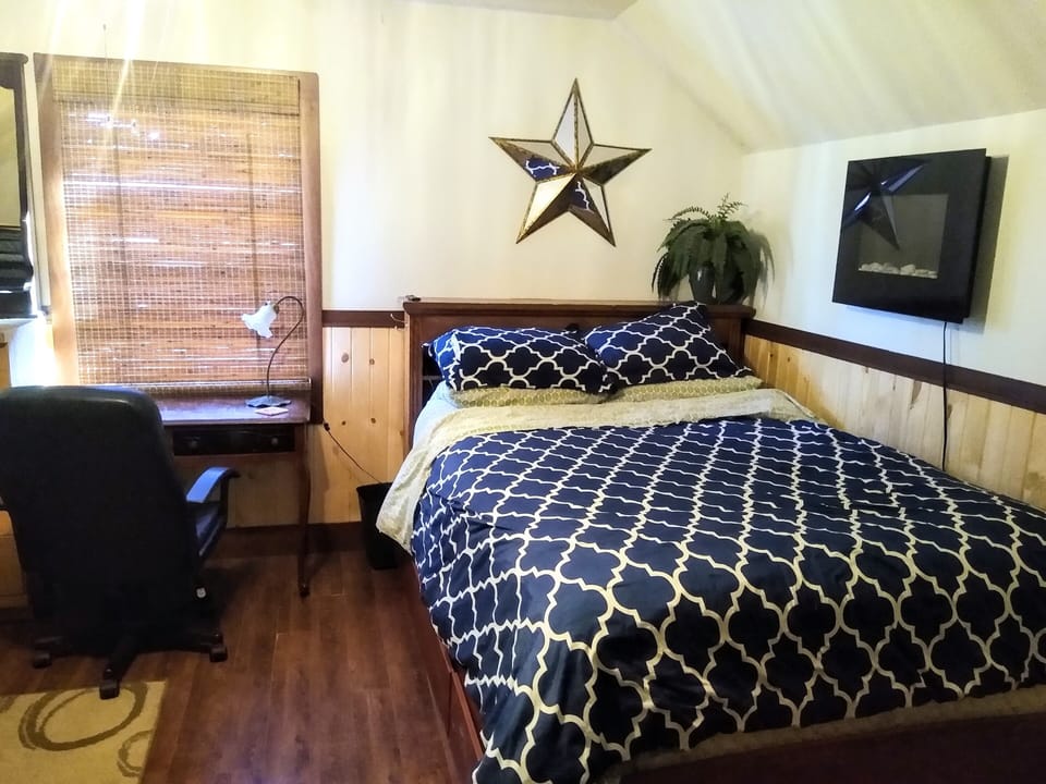 View from the doorway.  Queen size bed with heated mattress pad