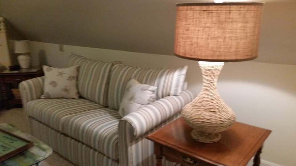 This brand new coastal style couch pulls out into a full size bed!