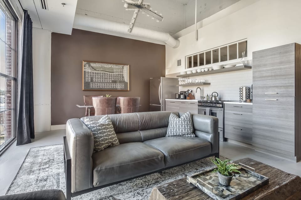 Living Area with Gray Leather Sofa at Ponce City Market Apartment
