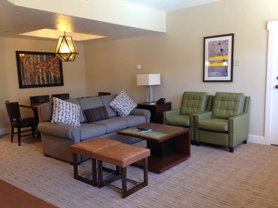 Family room with queen sofa bed  and dining room in the back.  Table seats 6.
